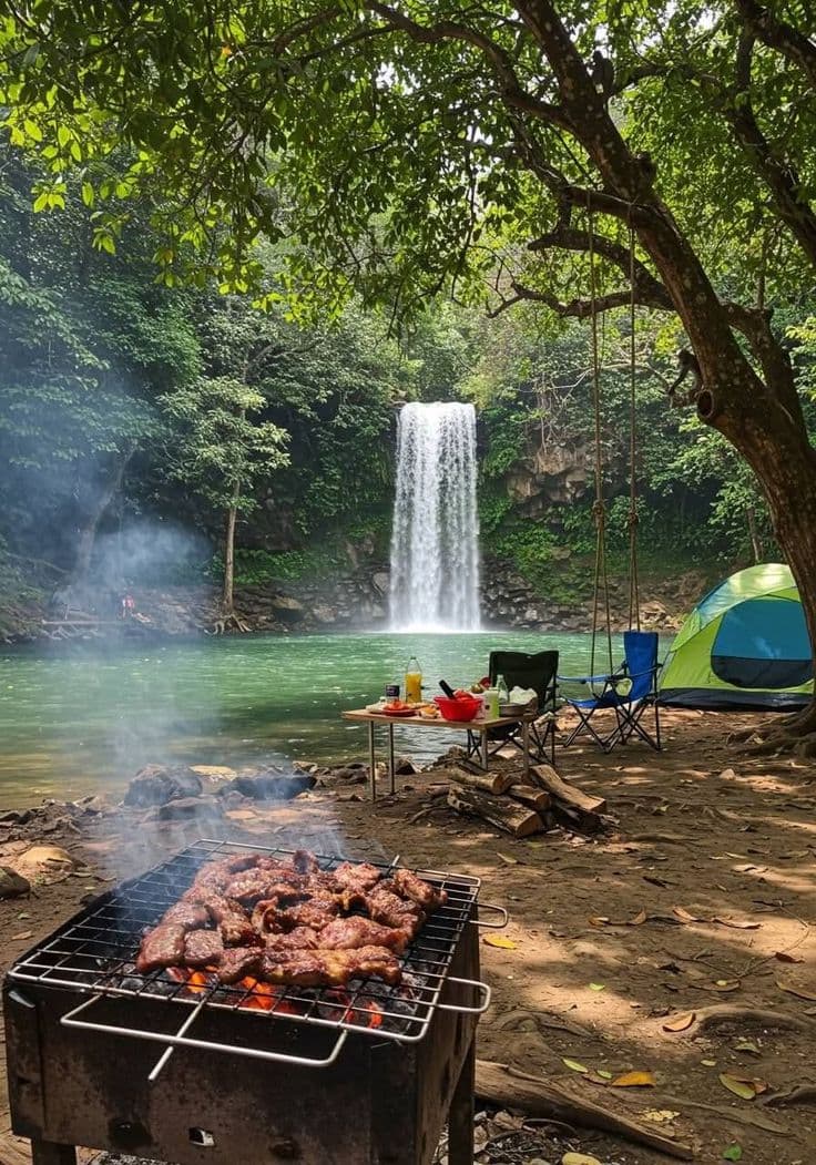 Campsite and barbecue beside a forest waterfall